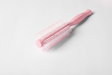 Photo of Hairdresser tool. Round pink brush on white background