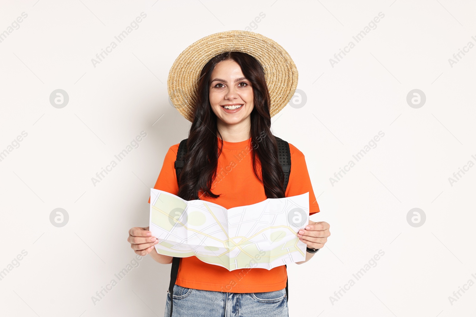 Photo of Young tourist in hat with map on white background