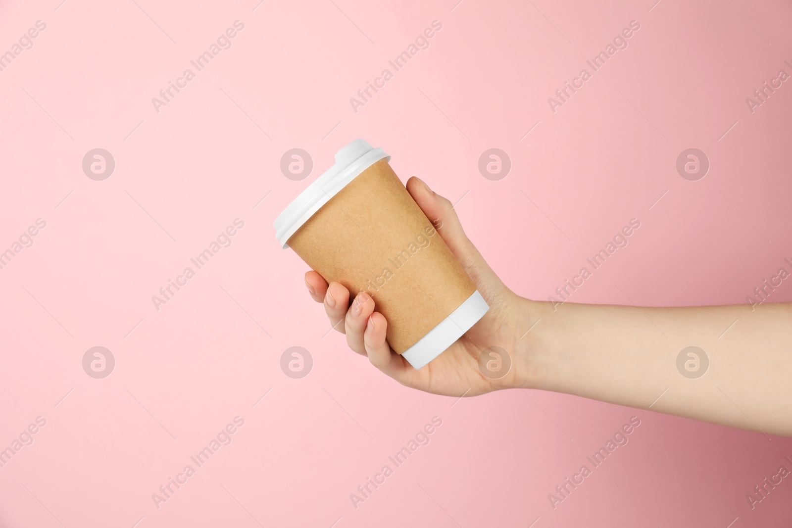 Woman holding paper cup on pink background, closeup. Mockup for design Photo of Woman holding paper cup on pink background, closeup. Mockup for design