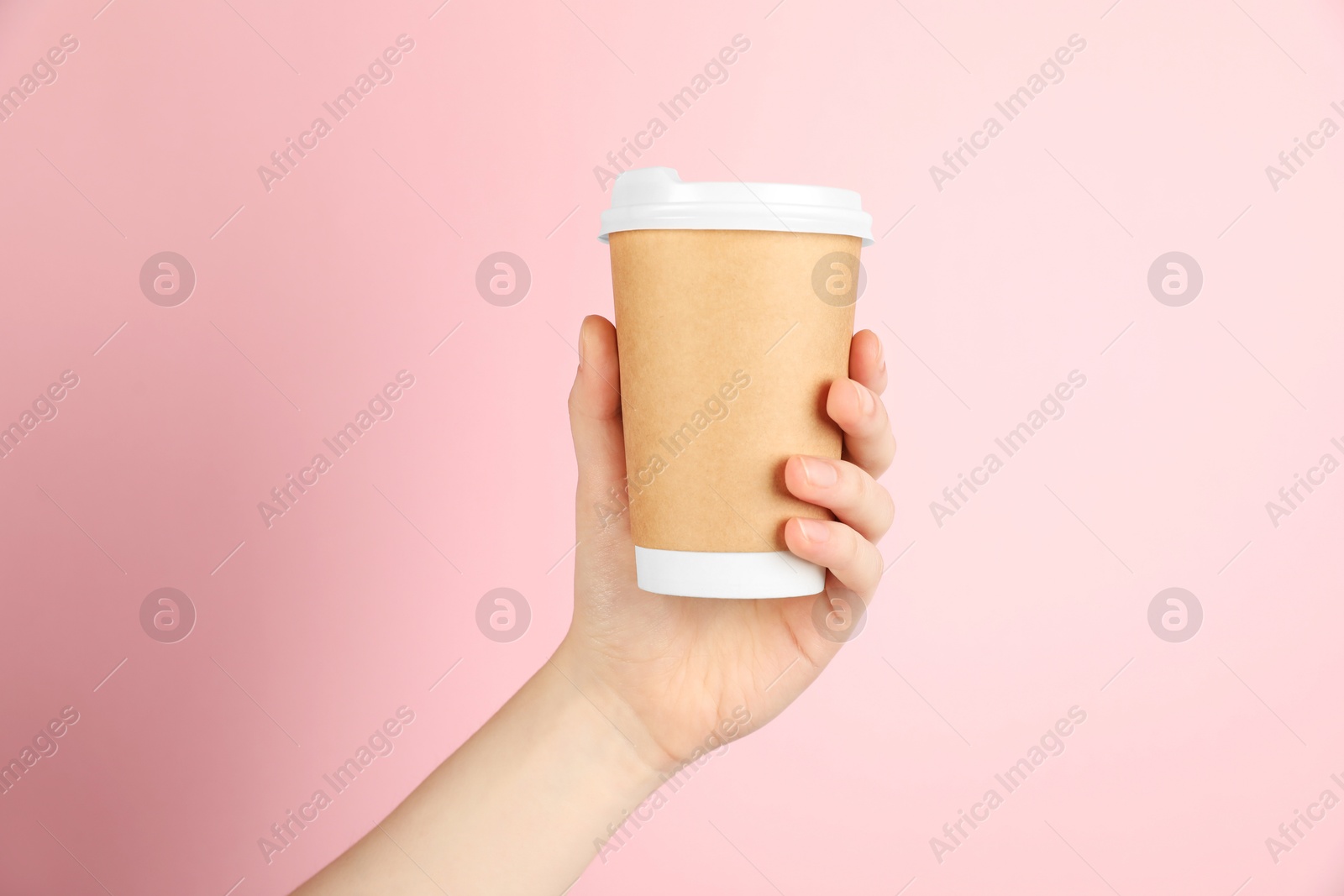 Woman holding paper cup on pink background, closeup. Mockup for design Photo of Woman holding paper cup on pink background, closeup. Mockup for design