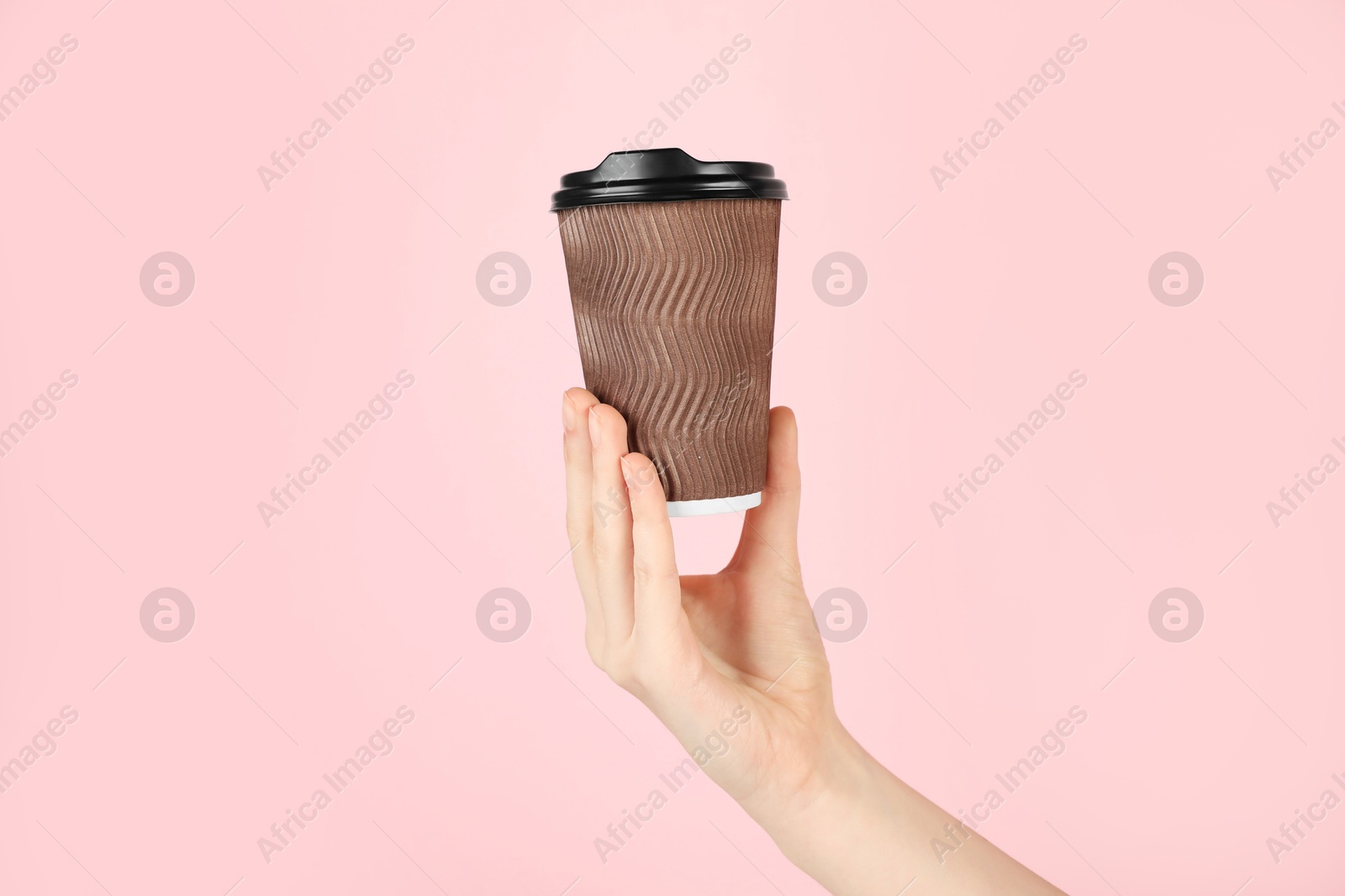 Woman holding paper cup on pink background, closeup. Mockup for design Photo of Woman holding paper cup on pink background, closeup. Mockup for design