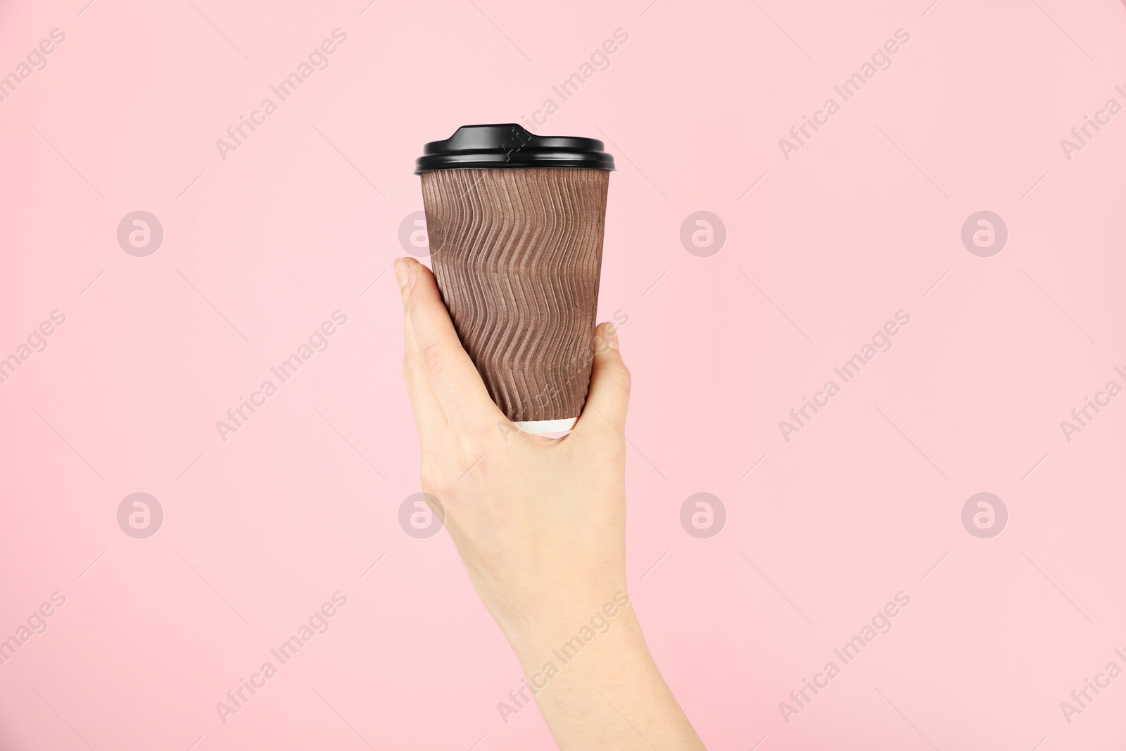 Woman holding paper cup on pink background, closeup. Mockup for design Photo of Woman holding paper cup on pink background, closeup. Mockup for design
