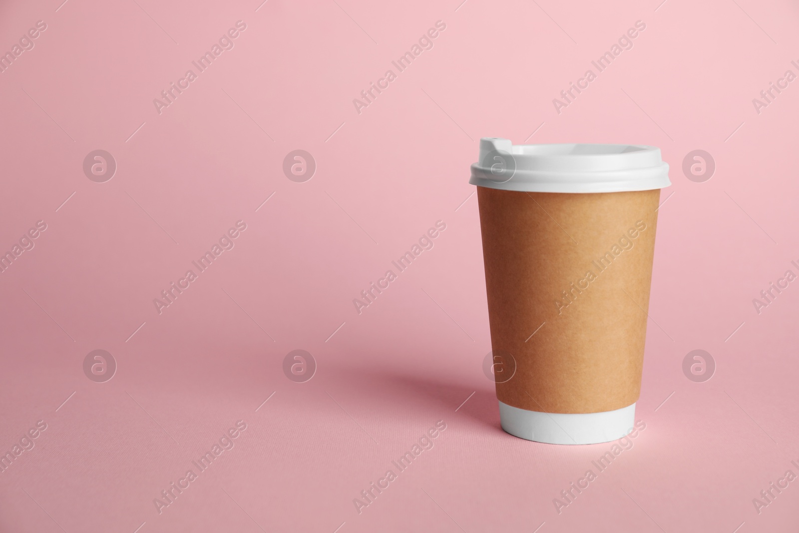 One paper cup on pink background. Mockup for design Photo of One paper cup on pink background. Mockup for design