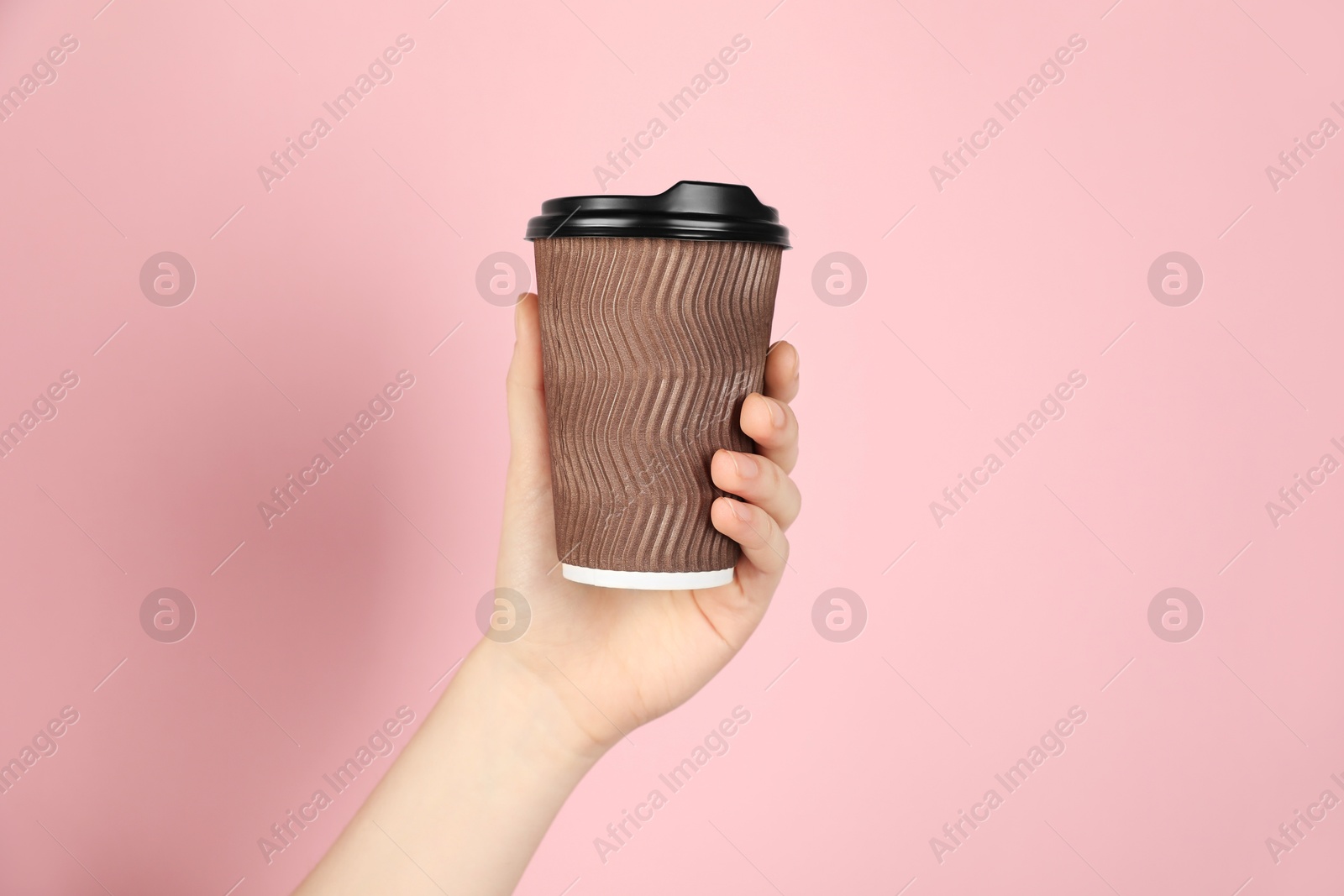Woman holding paper cup on pink background, closeup. Mockup for design Photo of Woman holding paper cup on pink background, closeup. Mockup for design
