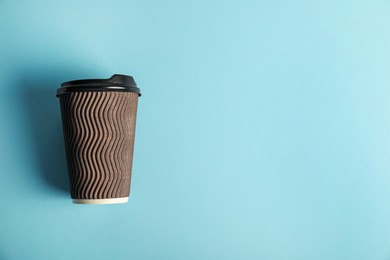 Photo of Paper cup on light blue background, top view. Mockup for design