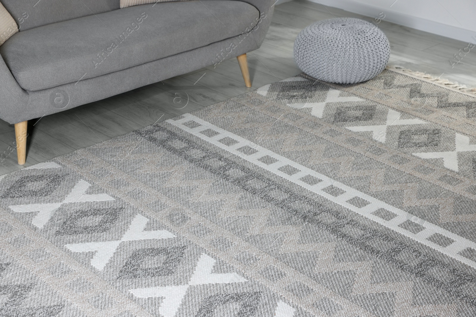 Photo of Stylish soft rug with pattern on floor in living room