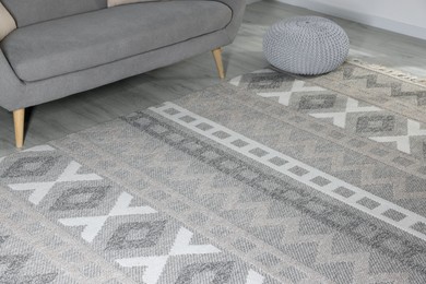 Photo of Stylish soft rug with pattern on floor in living room