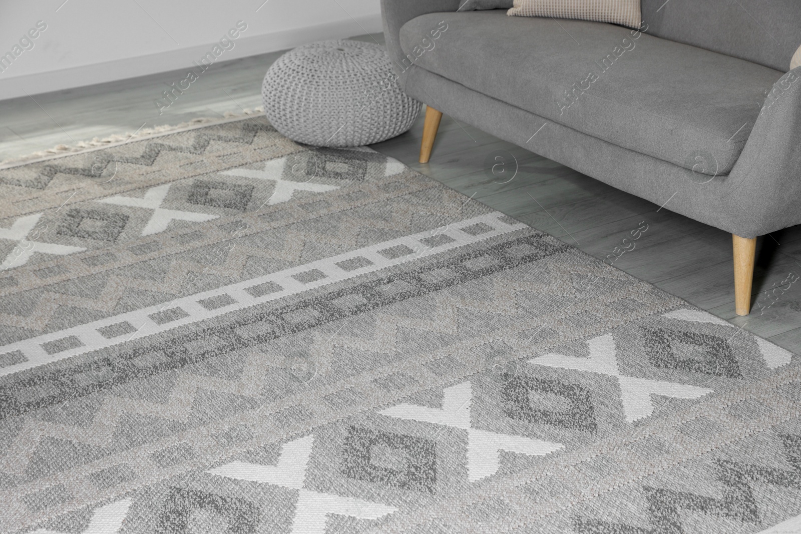 Photo of Stylish soft rug with pattern on floor in living room