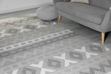 Photo of Stylish soft rug with pattern on floor in living room