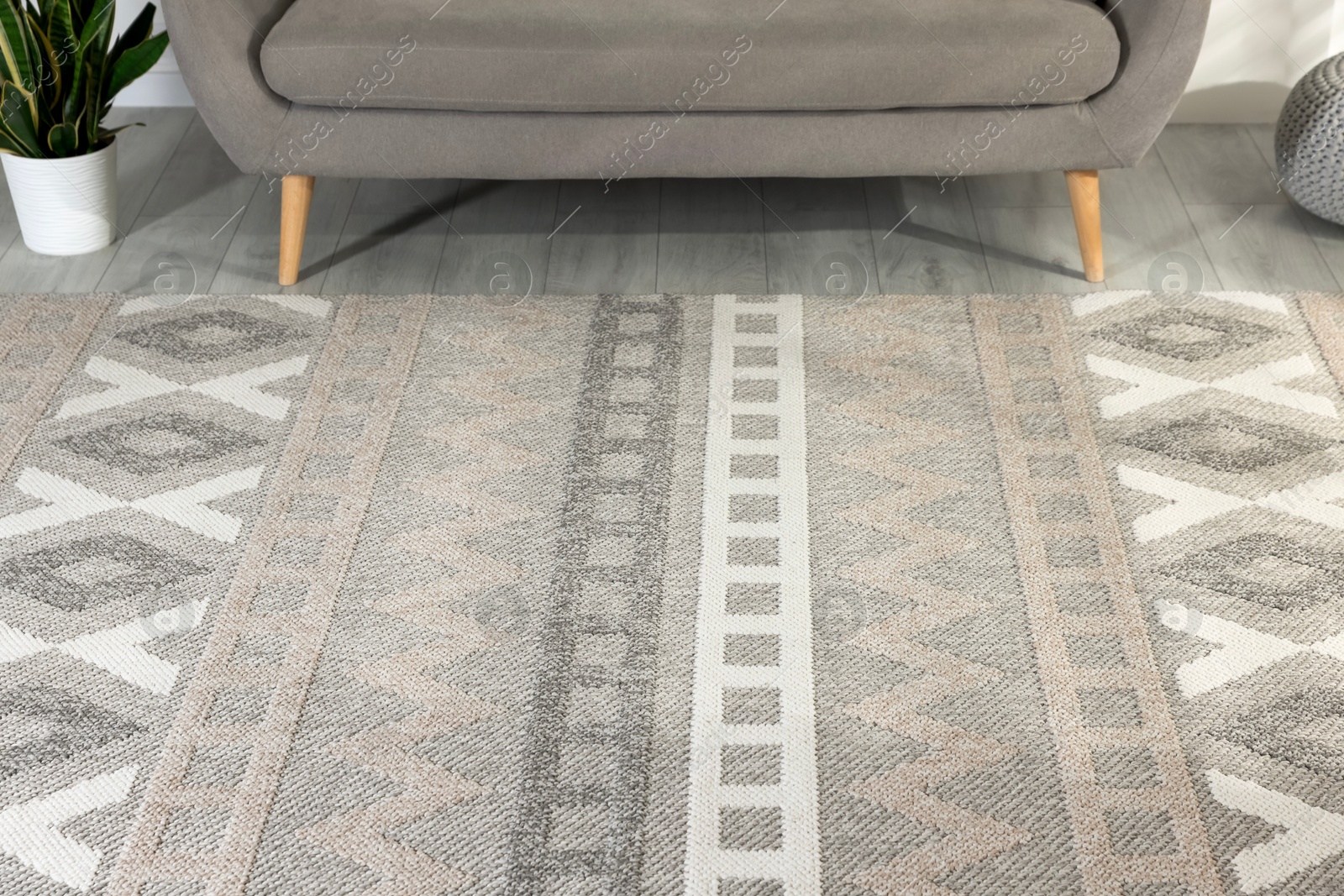 Stylish soft rug with pattern on floor in living room Photo of Stylish soft rug with pattern on floor in living room