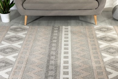 Photo of Stylish soft rug with pattern on floor in living room