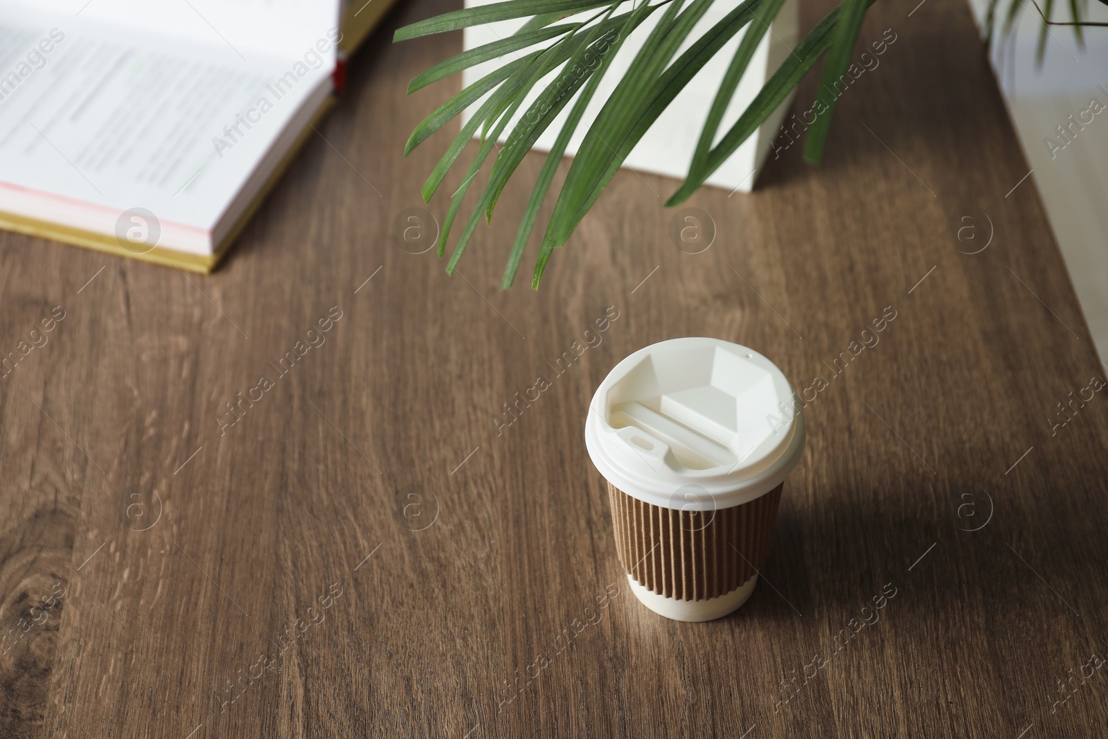 Paper cup on wooden table. Mockup for design Photo of Paper cup on wooden table. Mockup for design