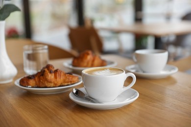 Photo of Delicious breakfast served on wooden table in cafe