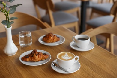 Photo of Delicious breakfast served on wooden table in cafe