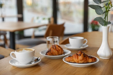 Photo of Delicious breakfast served on wooden table in cafe