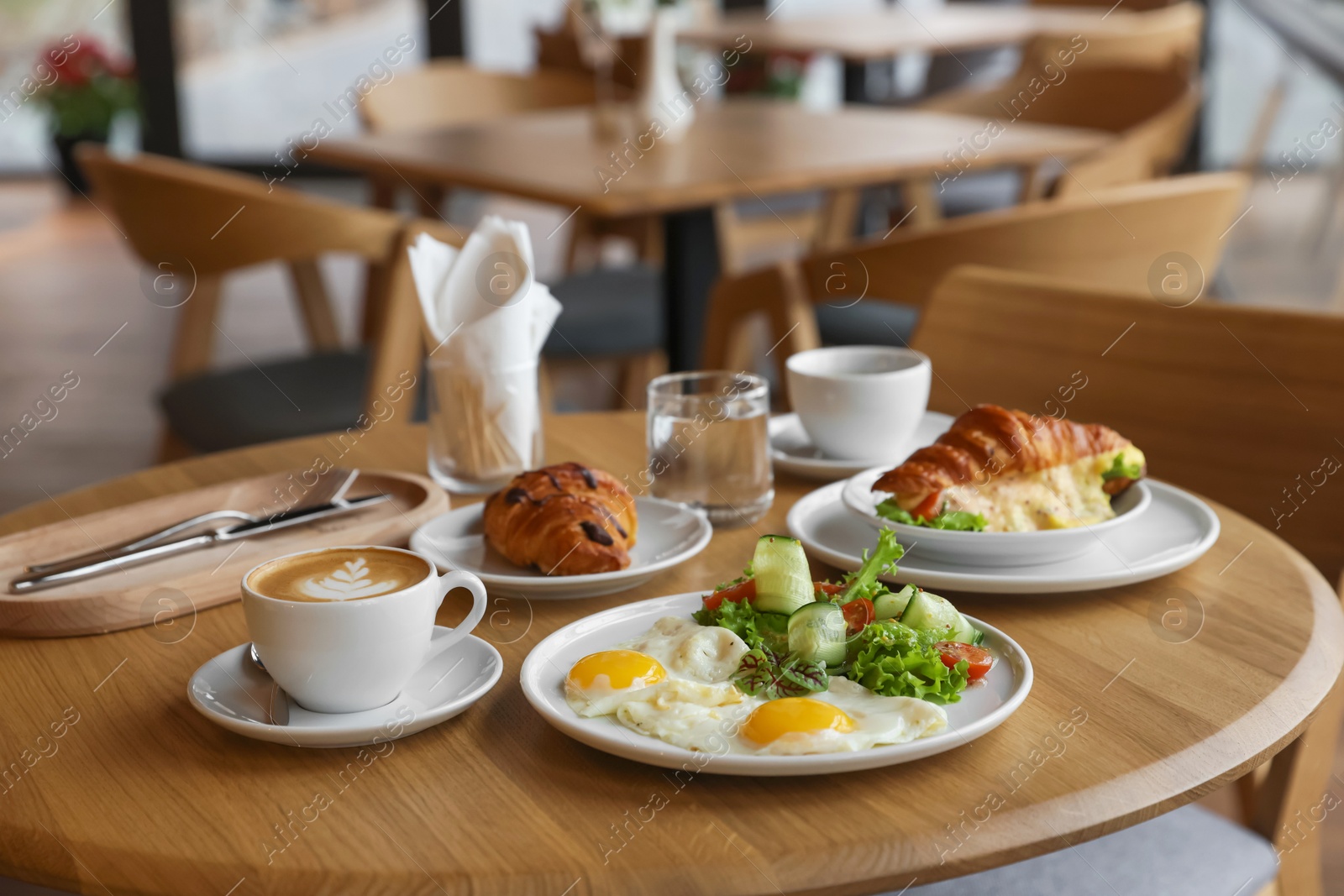 Photo of Delicious breakfast served on wooden table in cafe