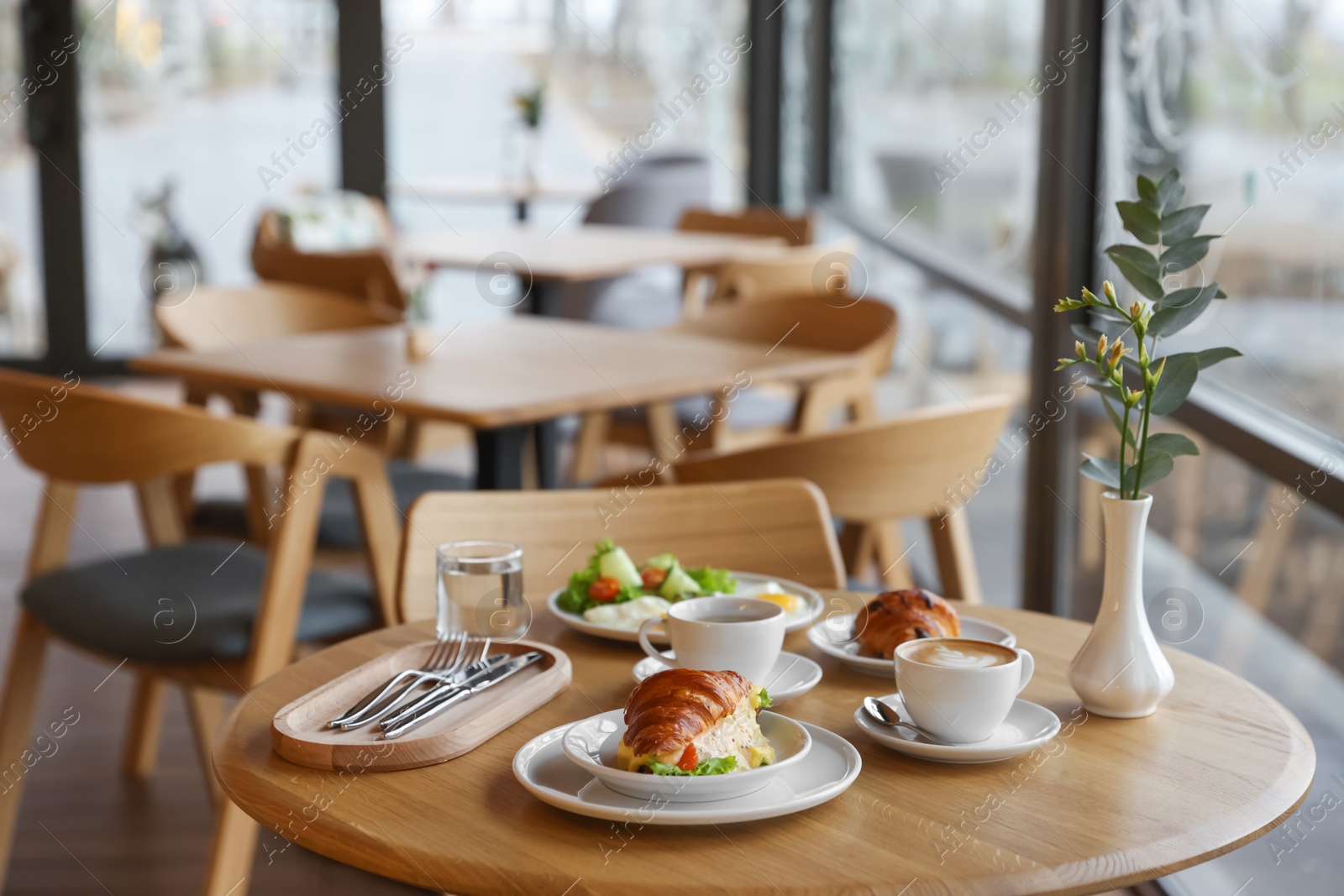 Photo of Delicious breakfast served on wooden table in cafe