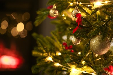 Photo of Beautiful decorated Christmas tree indoors, closeup. Bokeh effect