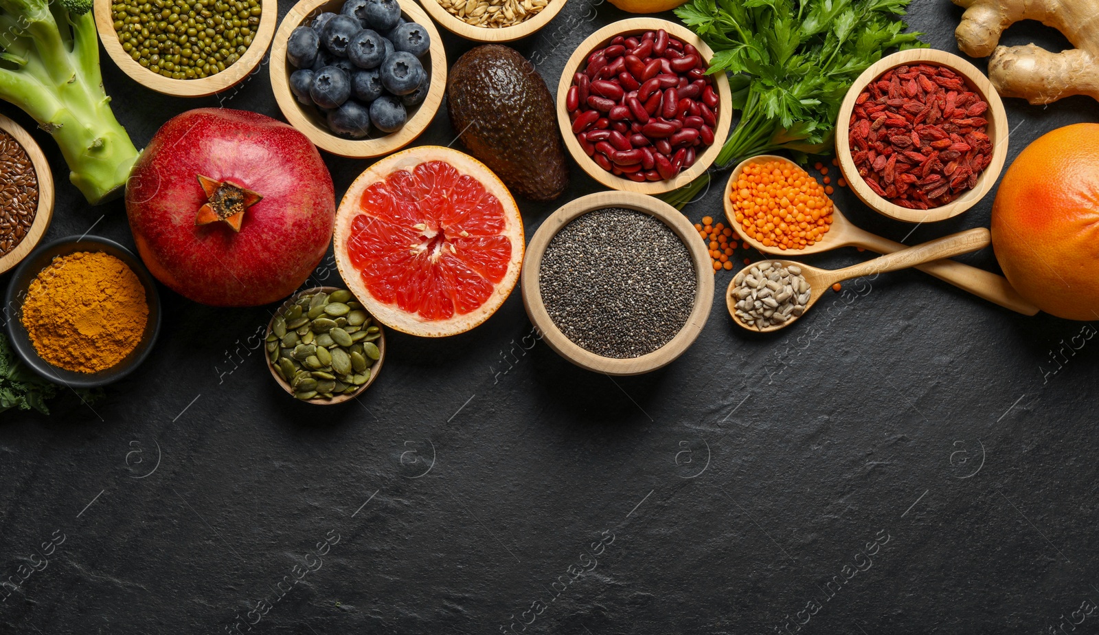 Photo of Superfood. Different healthy food products on grey table, flat lay. Space for text