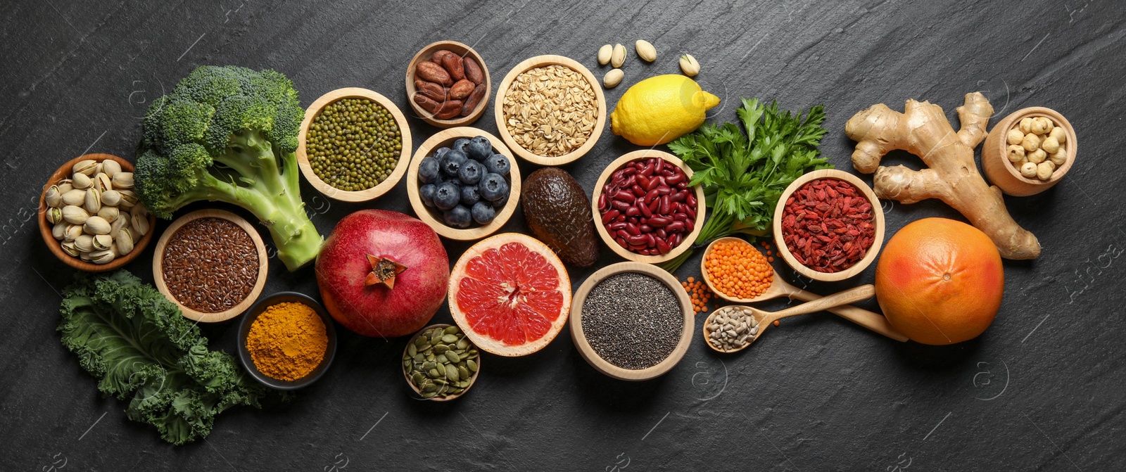 Photo of Superfood. Different healthy food products on grey table, flat lay