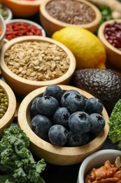 Photo of Superfood. Different healthy food products on grey table, closeup