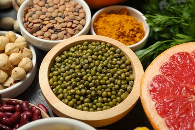 Photo of Superfood. Different healthy food products on grey table, closeup