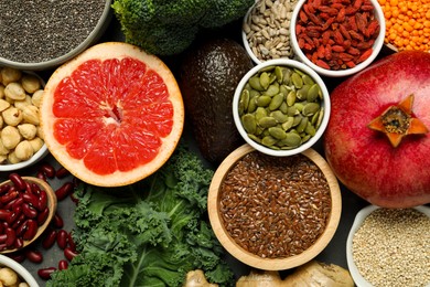 Photo of Superfood. Different healthy food products on grey table, flat lay