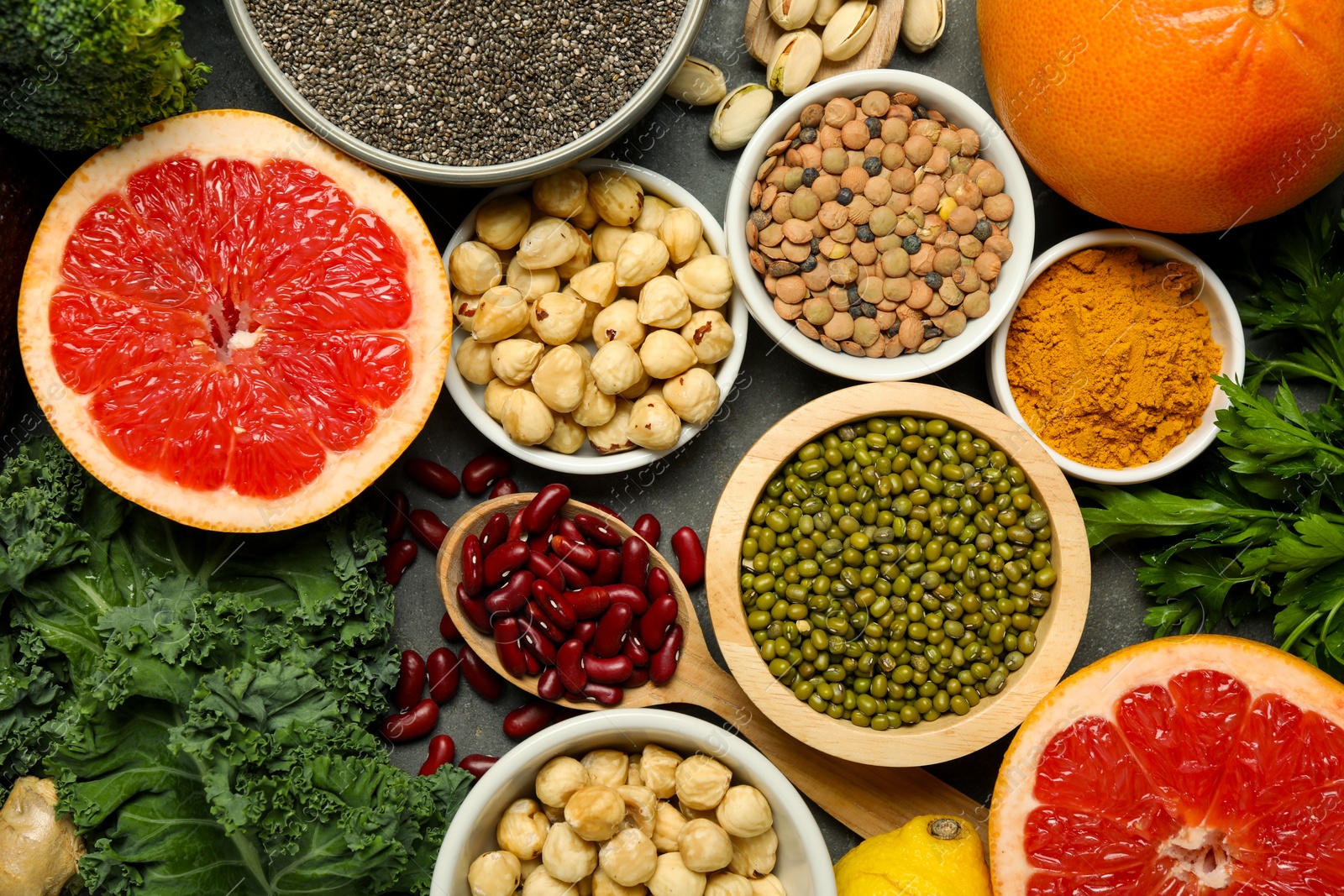 Photo of Superfood. Different healthy food products on grey table, flat lay