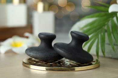 Photo of Massage stones on table, closeup. Spa treatment