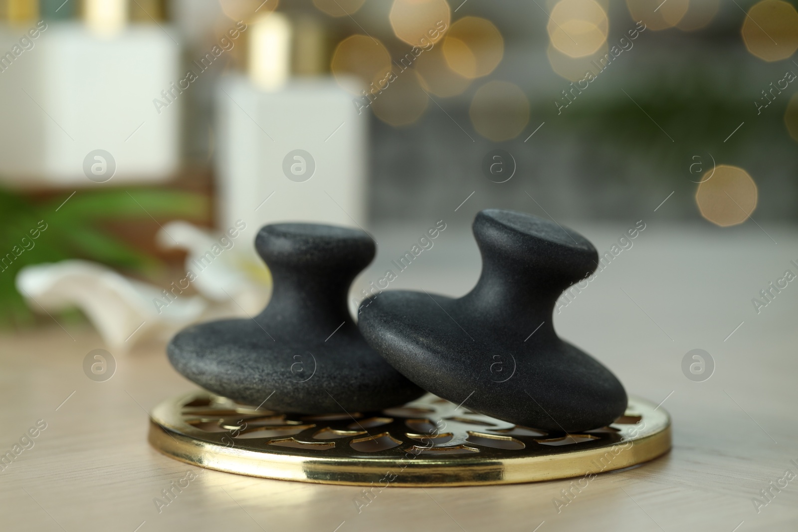 Photo of Massage stones on table, closeup. Spa treatment