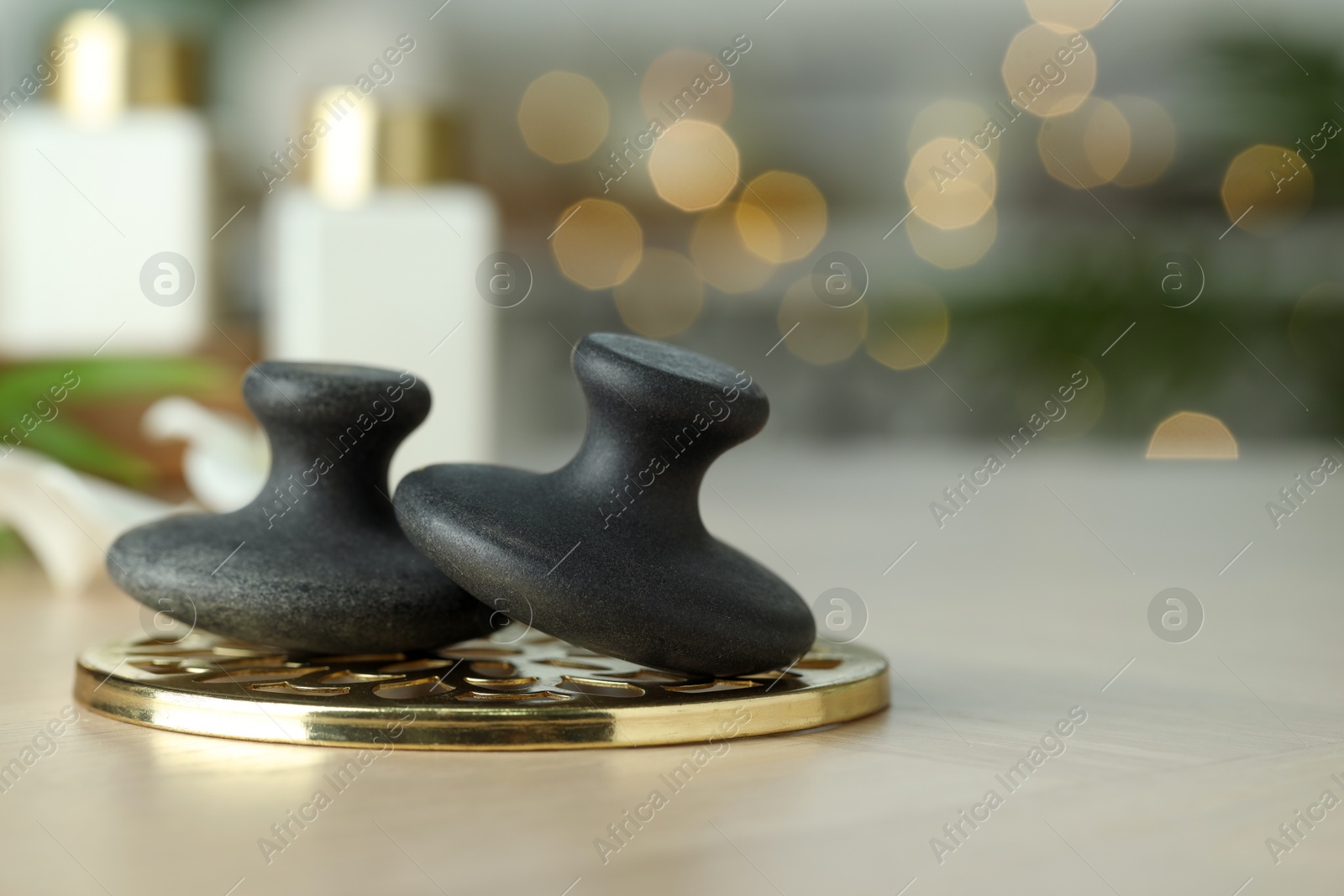 Photo of Spa stones on table, closeup. Space for text