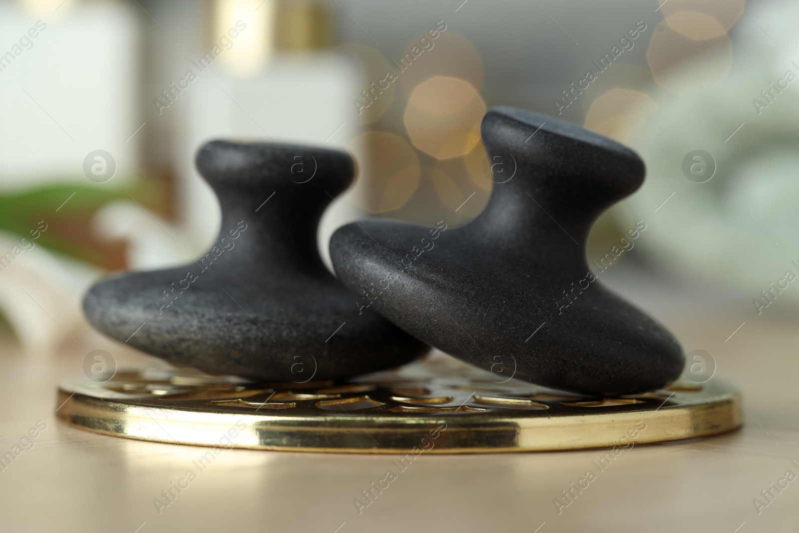 Photo of Massage stones on table, closeup. Spa treatment