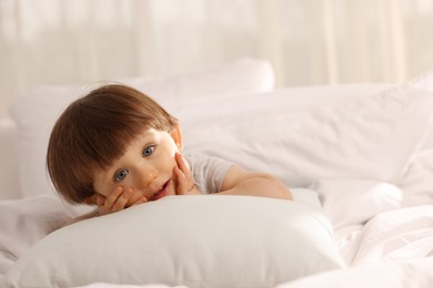 Photo of Cute little boy in bed at home, space for text