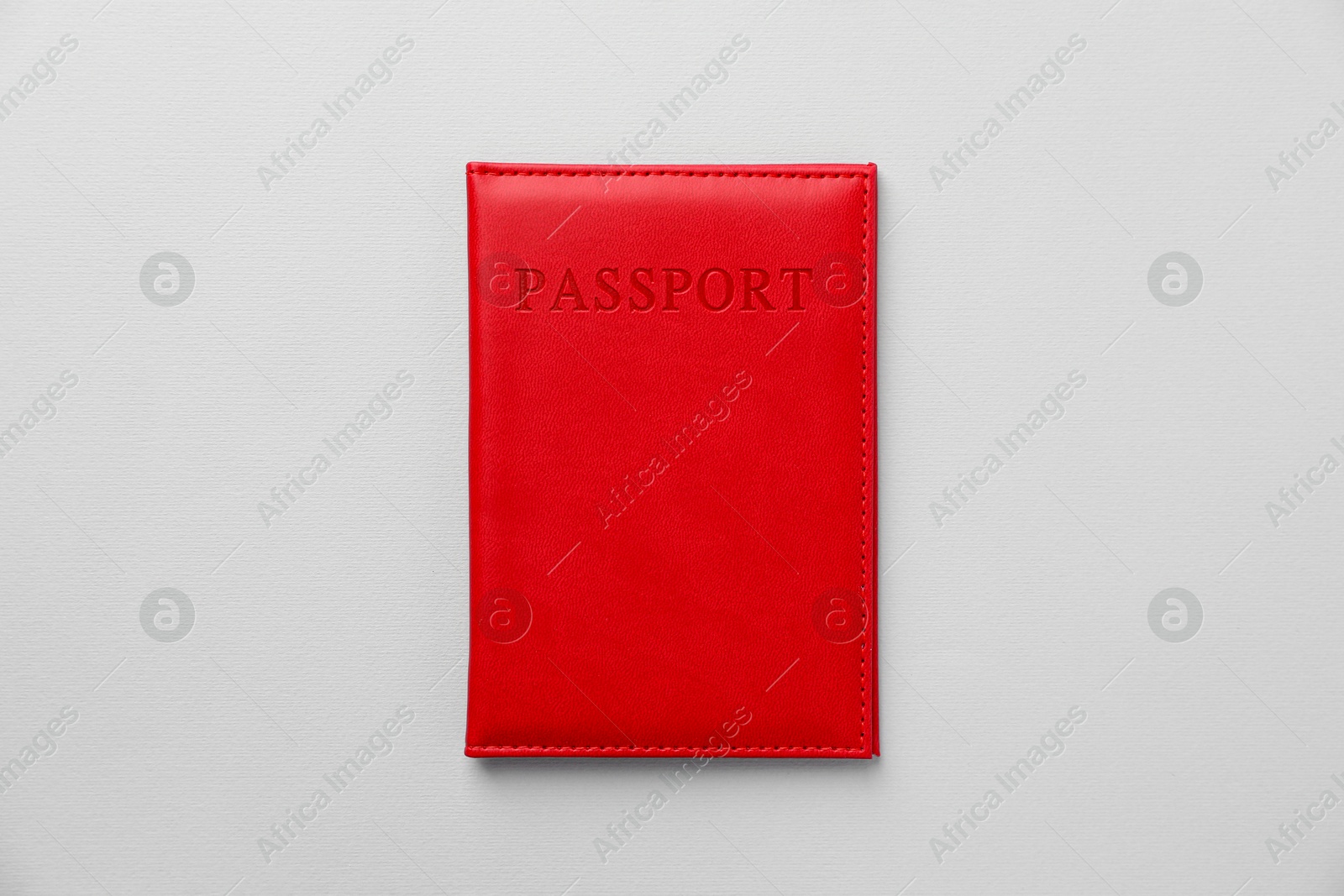 Photo of Passport in bright cover on grey background, top view