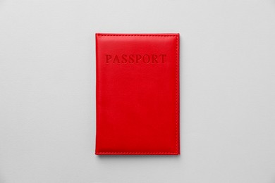 Photo of Passport in bright cover on grey background, top view