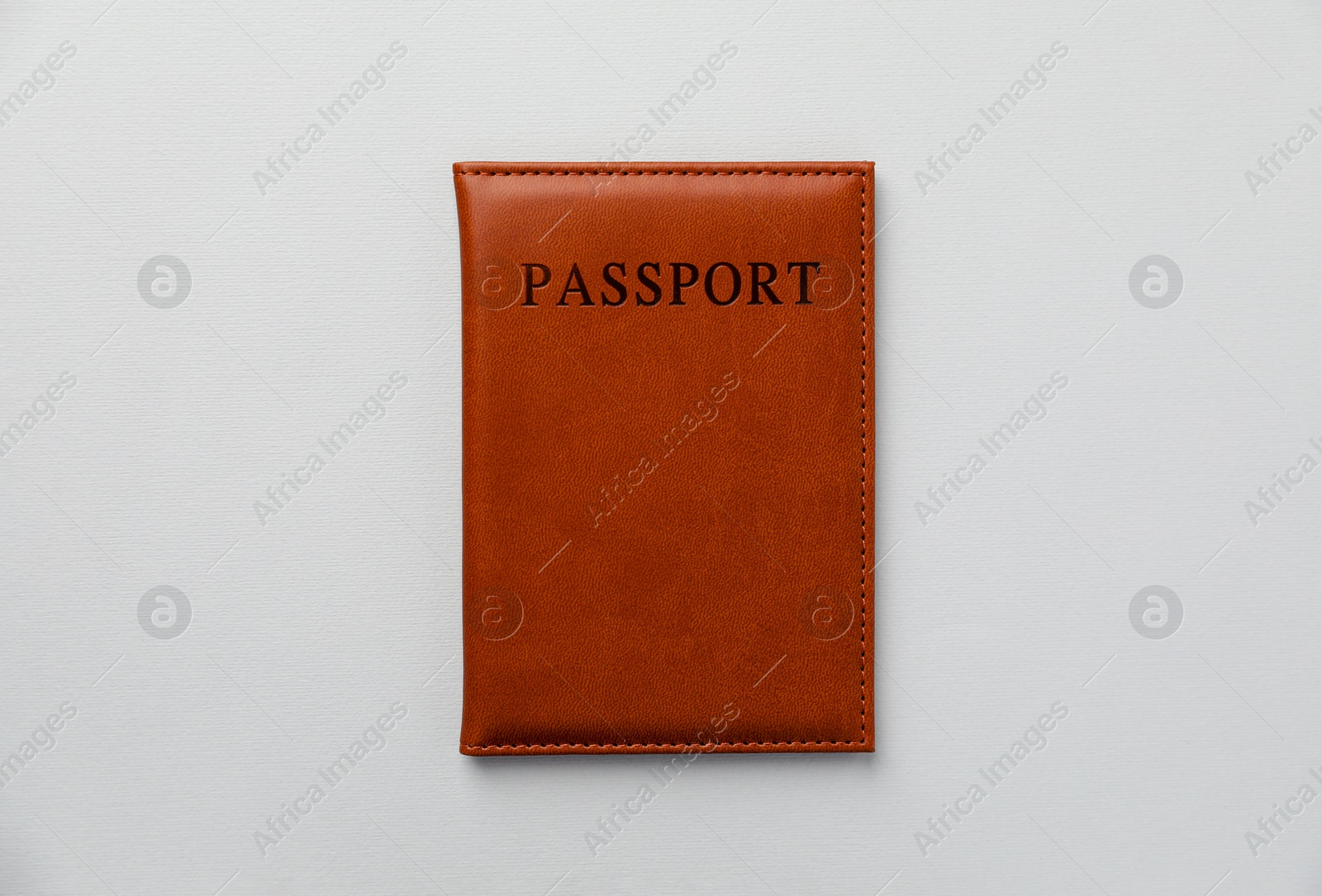 Photo of Passport in leather cover on grey background, top view