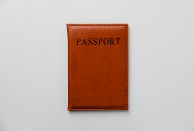 Photo of Passport in leather cover on grey background, top view