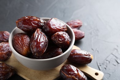 Photo of Tasty dried dates on grey table, closeup