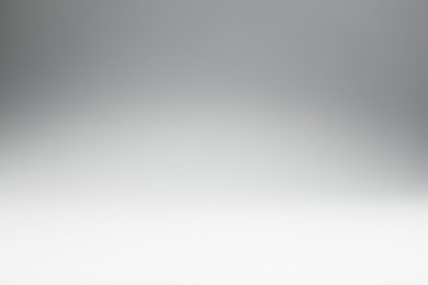 Photo of Light grey gradient background. Abstract color backdrop for design