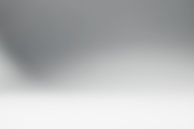 Photo of Light grey gradient background. Abstract color backdrop for design