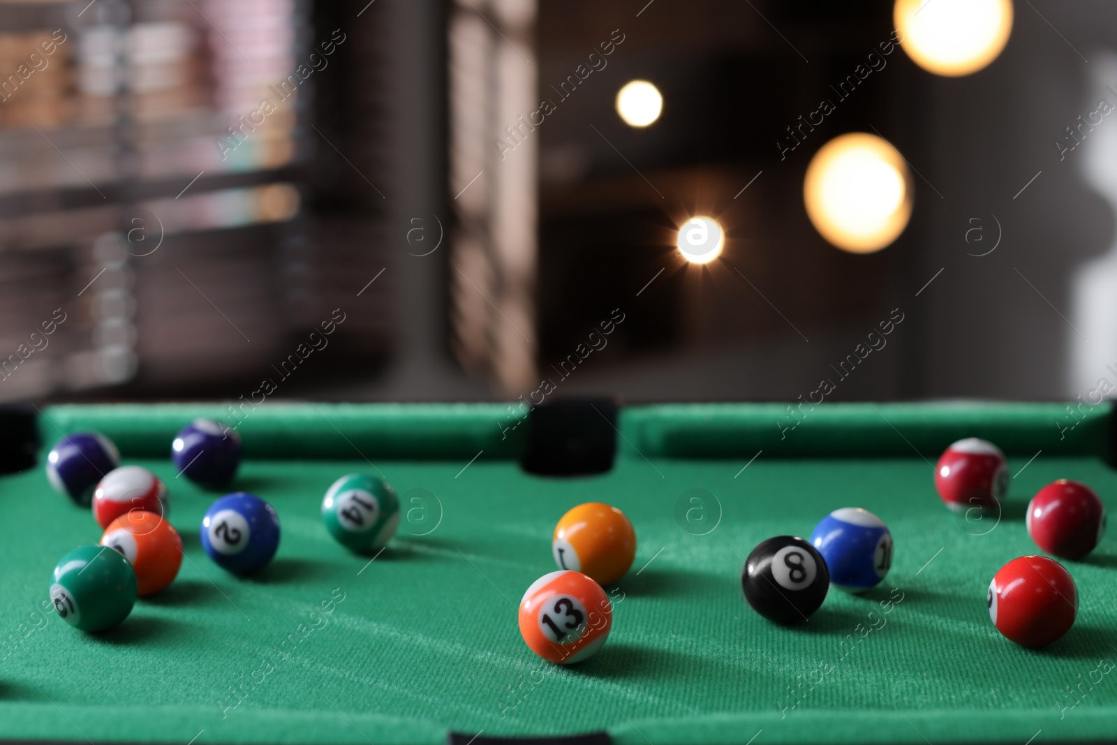 Photo of Many colorful billiard balls on green table indoors, space for text