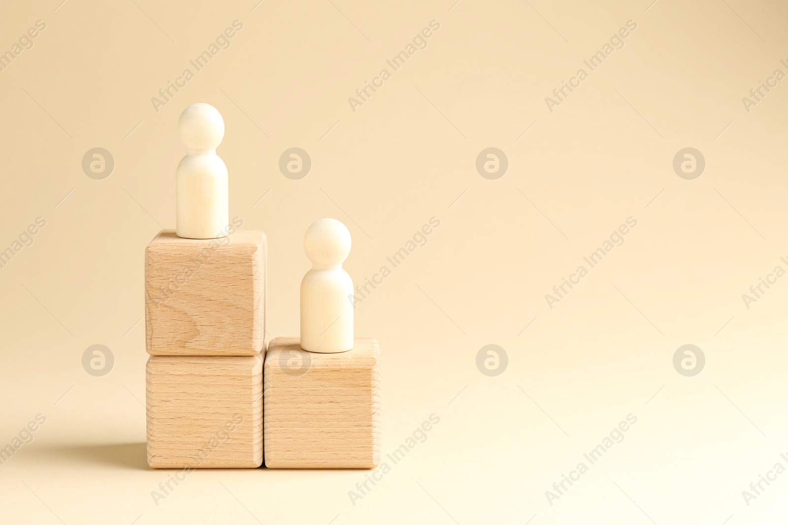 Photo of Competition concept. Human figures on wooden cubes against beige background, space for text