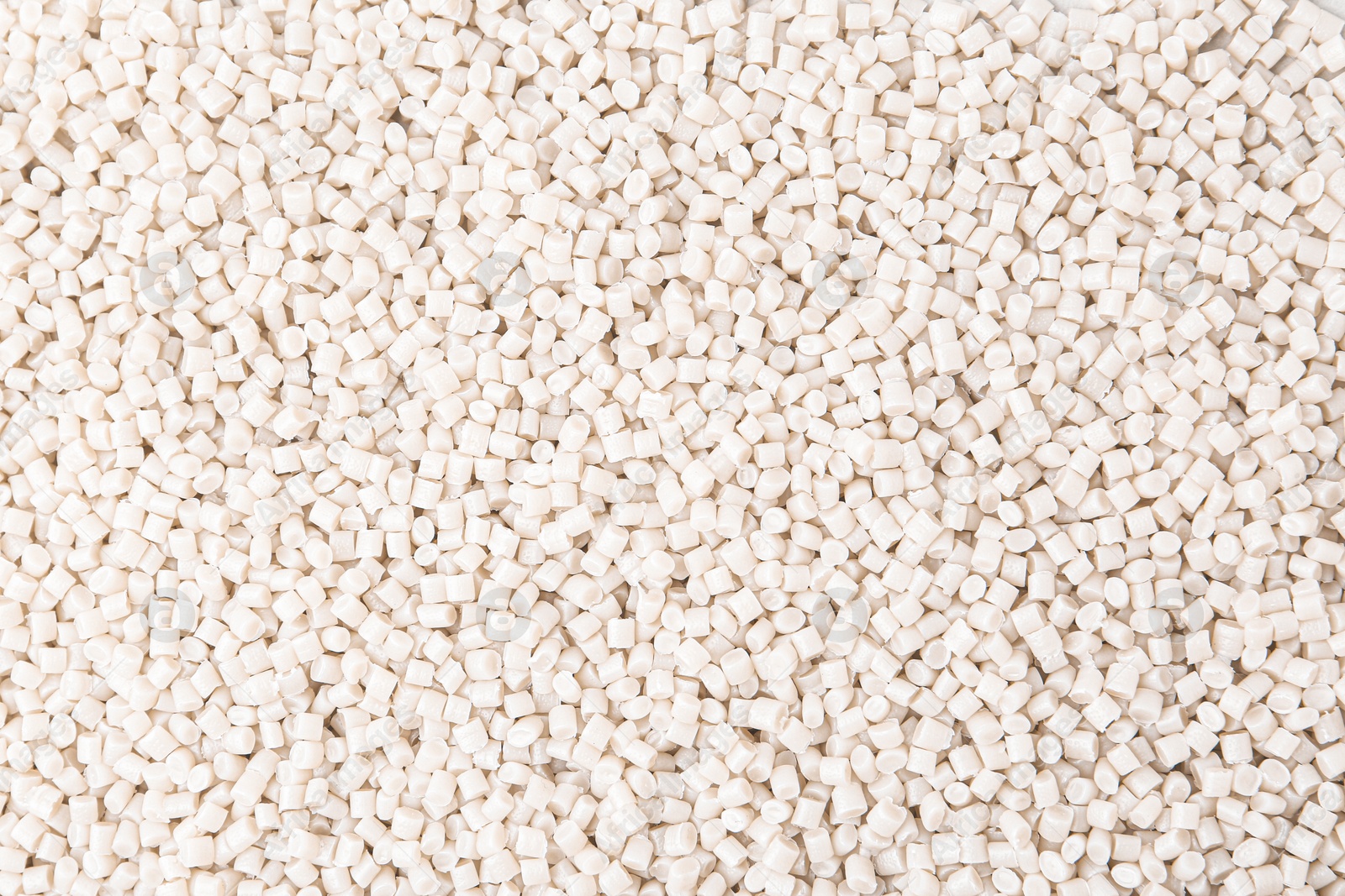 Photo of Pile of plastic granules as background, top view