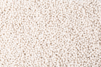 Photo of Pile of plastic granules as background, top view