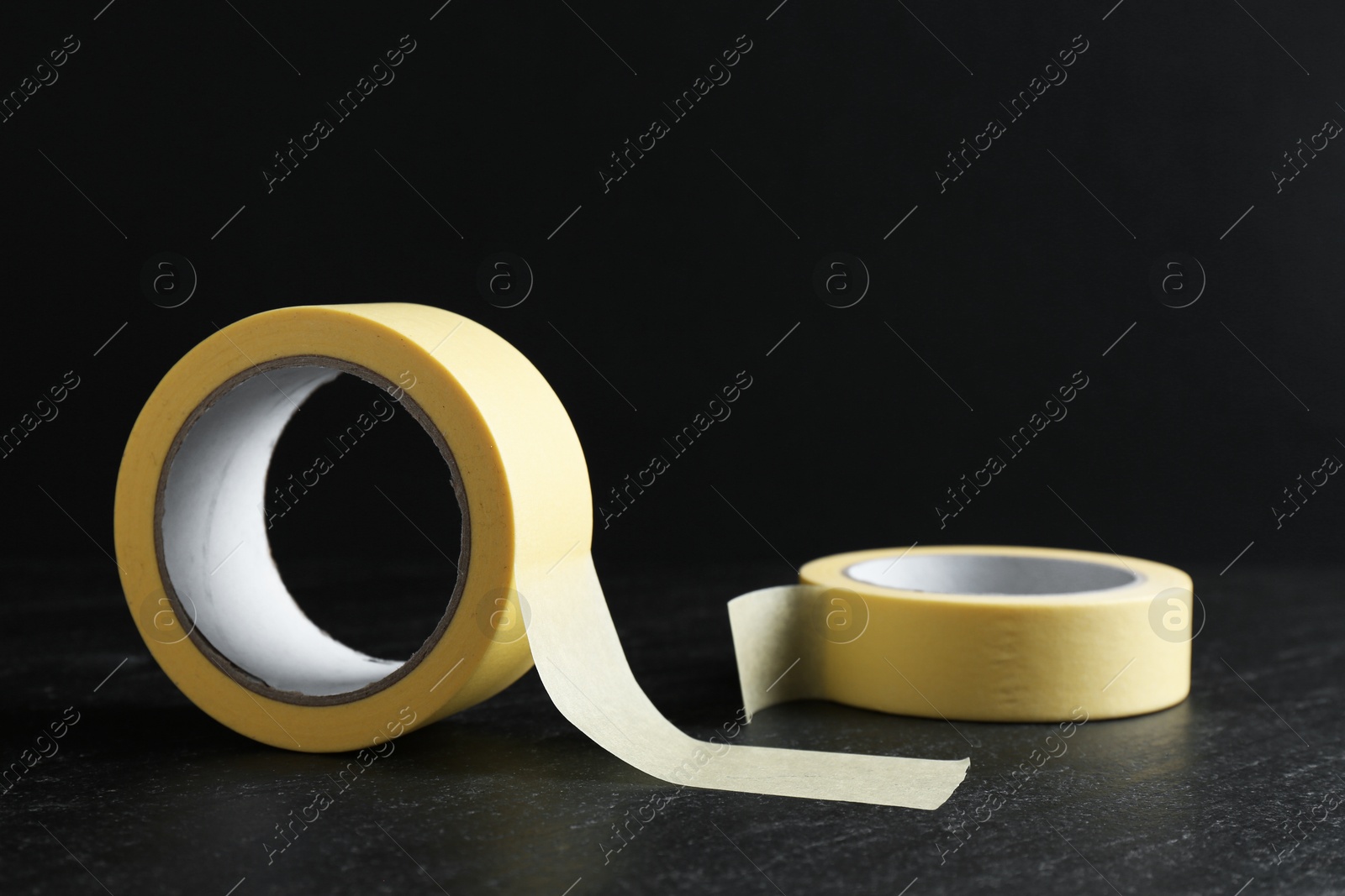 Photo of Rolls of masking tape on black table