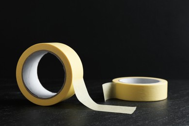 Rolls of masking tape on black table