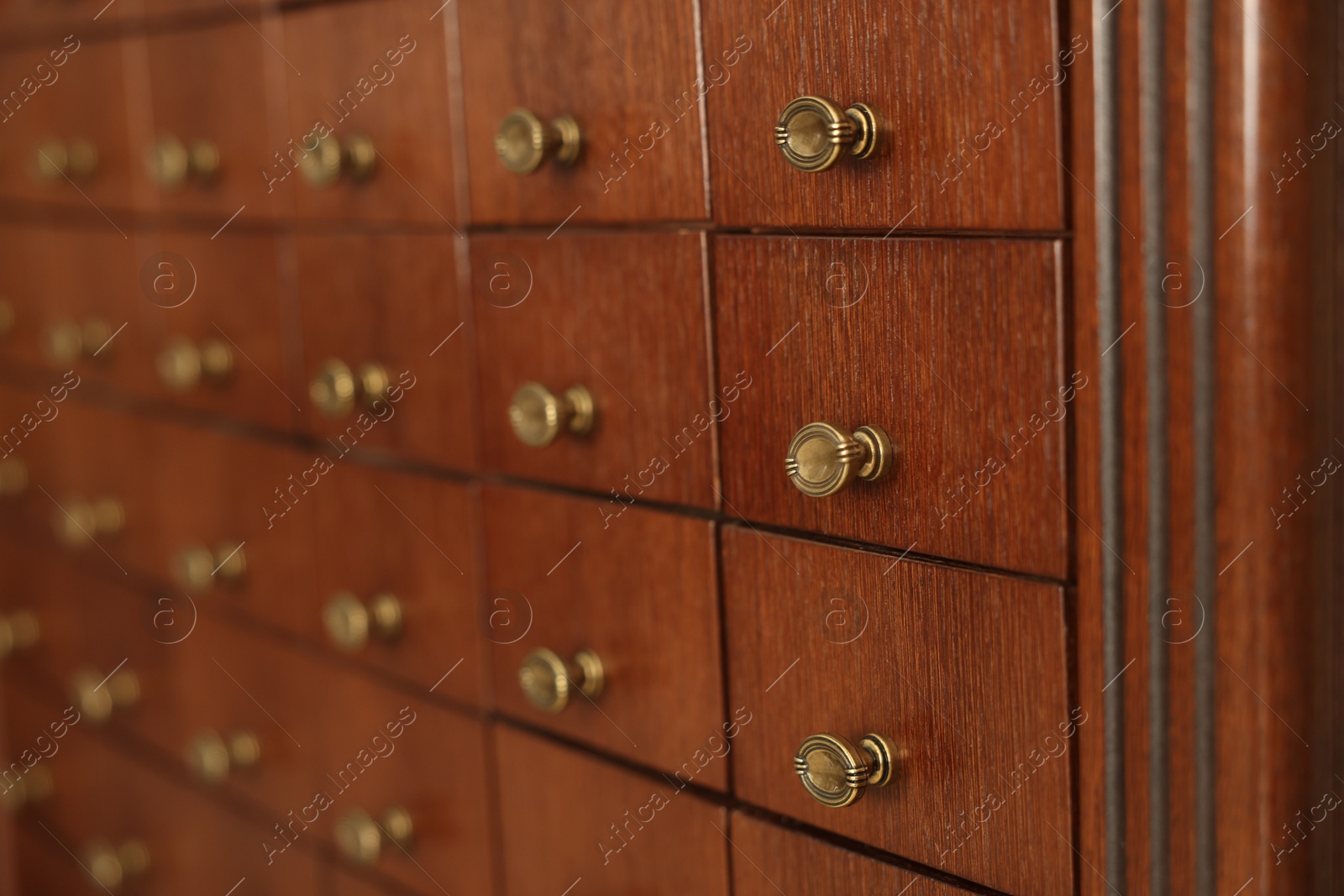 Photo of Wooden cabinet with many drawers, closeup view