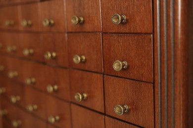 Photo of Wooden cabinet with many drawers, closeup view