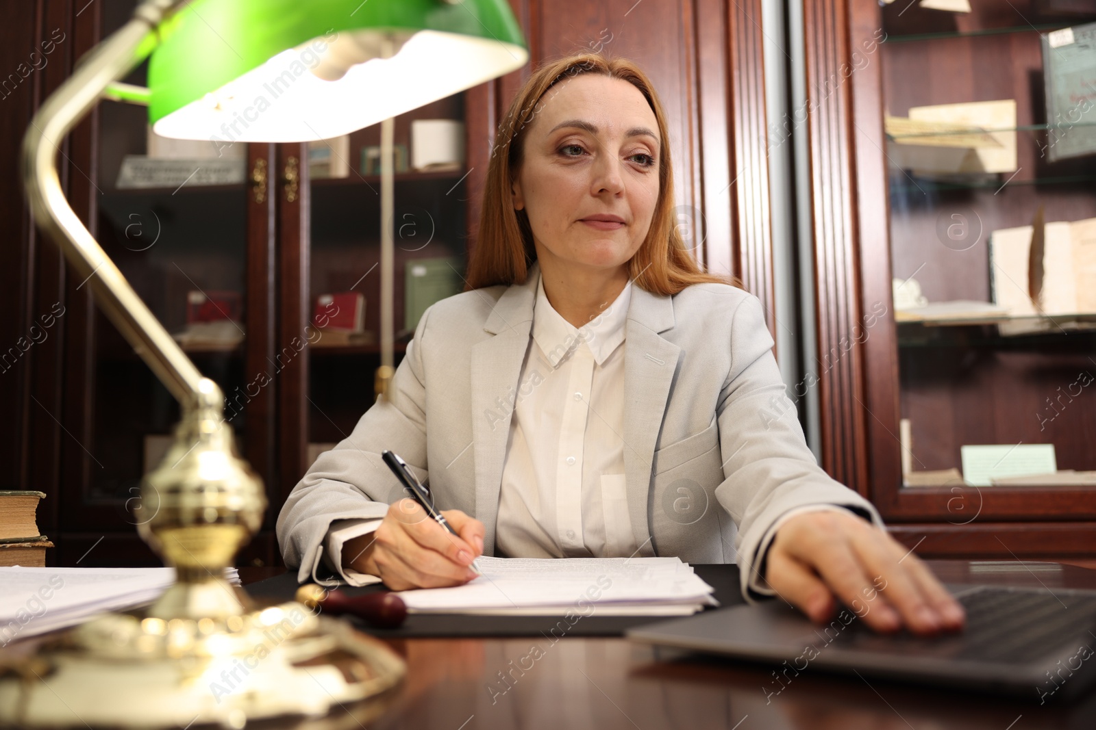 Photo of Notary working with laptop at table in office