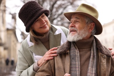 Photo of Happy senior couple walking on city street